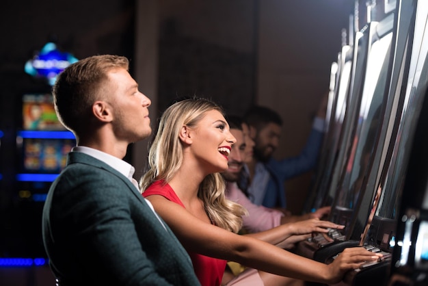 Grupo de personas en la máquina automática en el casino