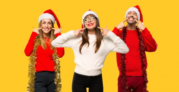 Un grupo de personas Mujer rubia vestida para las fiestas navideñas sonriendo con una agradable e