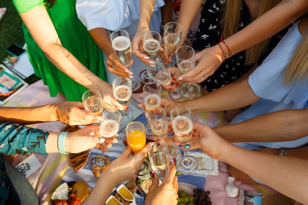 Grupo de personas que tienen juntos comida de picnic al aire libre comedor tostar vasos