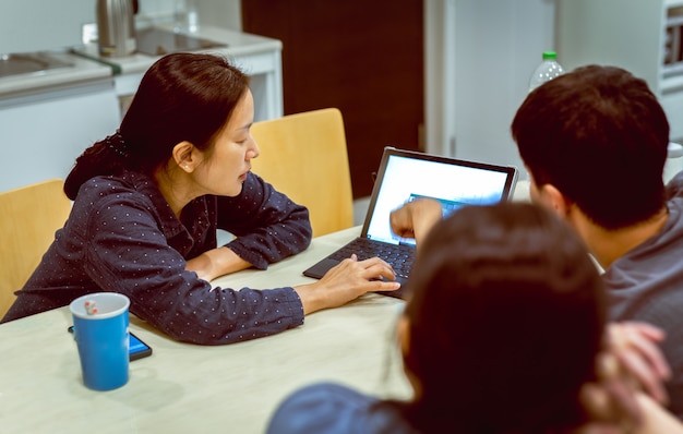 Grupo de trabajo en equipo de personas que trabajan en la computadora portátil a altas horas de la noche