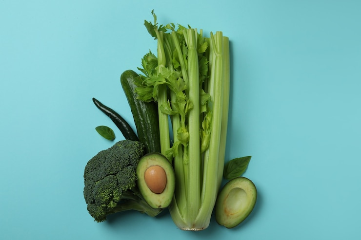 Foto grupo de verduras frescas sobre fondo azul.