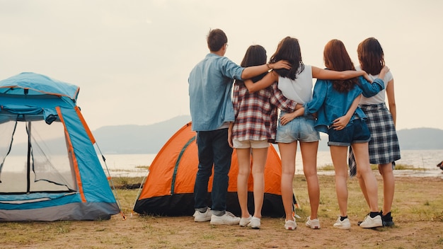 Gruppe der besten Freunde Asiens, Teenager, haben Spaß beim Blick auf den schönen Sonnenuntergang und genießen glückliche Momente zusammen neben dem Lager und den Zelten im Nationalpark