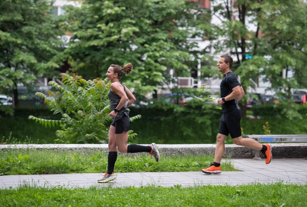 Gruppe gesunde Leute, die im Stadtpark rütteln, Läufer team auf Morgentraining