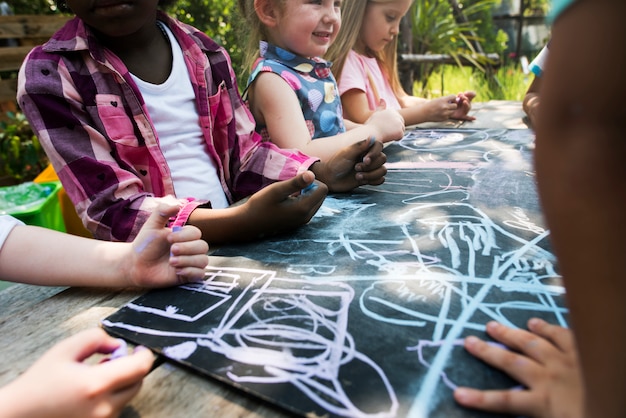 Foto gruppe kindergarten scherzt die freunde, die draußen kunstunterricht zeichnen