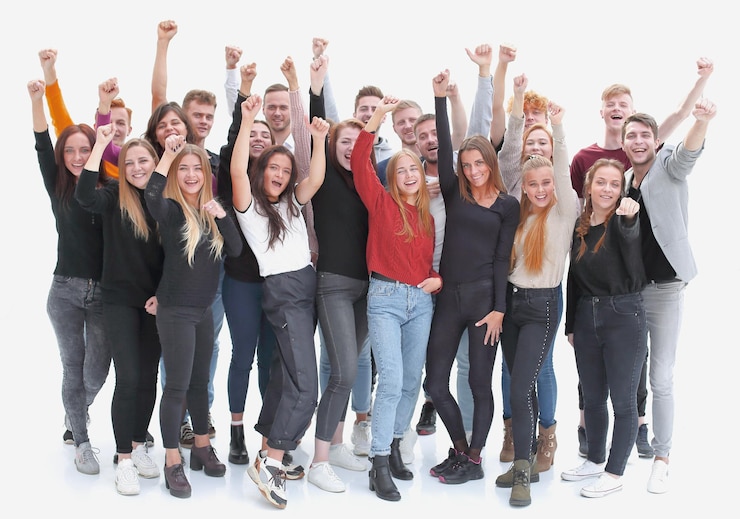Foto gruppe selbstbewusster junger leute, die mit erhobenen händen stehen