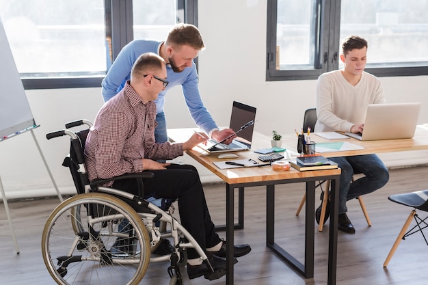 Gruppe von erwachsenen Männern, die zusammen im Büro arbeiten