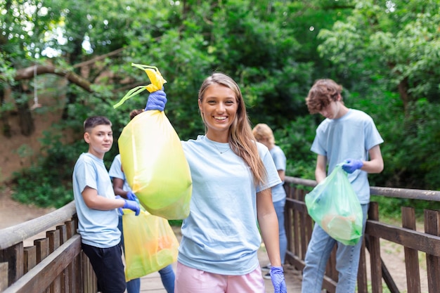 Gruppe von Freiwilligen, die den Wald vom Abfall-Community-Service-Konzept säubern