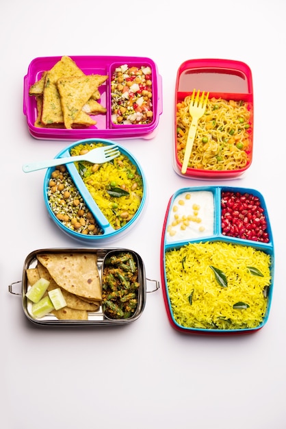 Foto gruppe von lunchboxen oder tiffin für indische kinder, die vielfalt oder mehrere optionen oder kombinationen von gesundem essen für ihre schulkinder zeigen