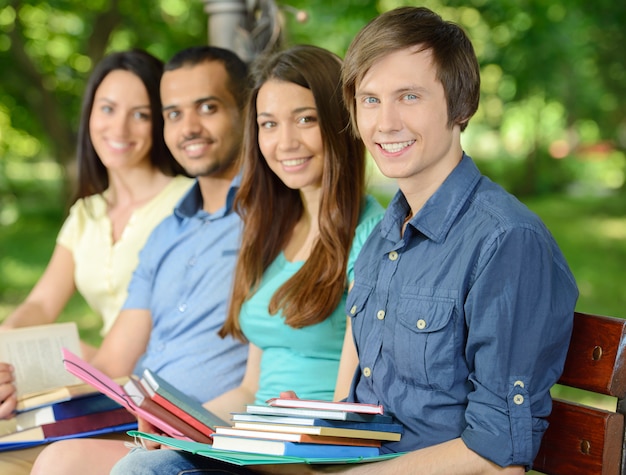 Gruppenporträt von vier lächelnden netten Studenten.