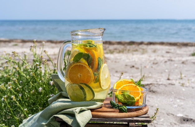 Água com infusão de desintoxicação com hortelã e laranja limão com vista para a costa do mar