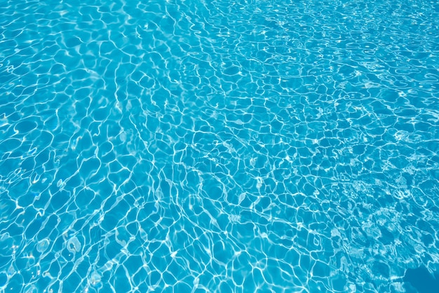 Água ondulada azul e brilhante e superfície na piscina