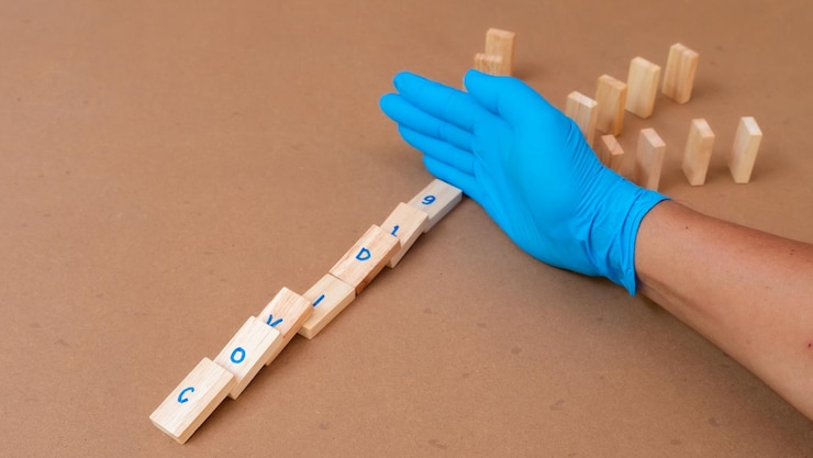 Foto guante de mano recortado con bloques de juguete en la mesa