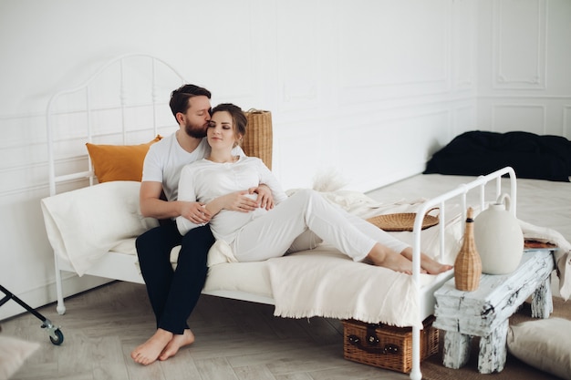 Guapa pareja enamorada pasa mucho tiempo libre juntos y se acuesta en una cama