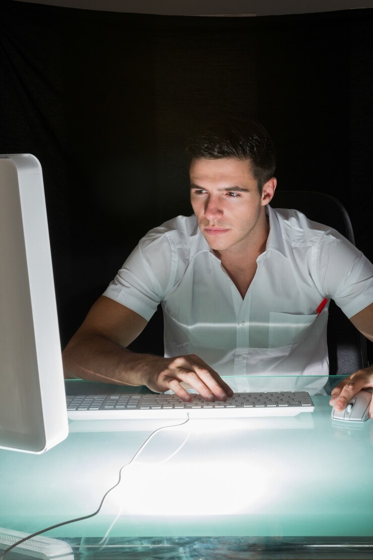 Foto guapo ingeniero informático concentrado trabajando en la noche