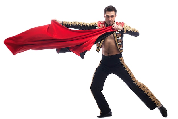 Foto un guapo torero con un traje negro y una tela roja.