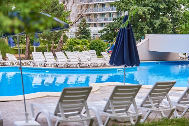 Guarda-chuva e cadeiras da piscina do hotel