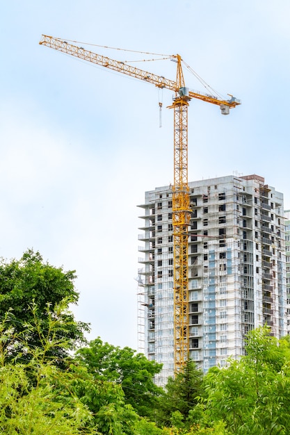 Guindaste de torre no fundo de um prédio em construção.