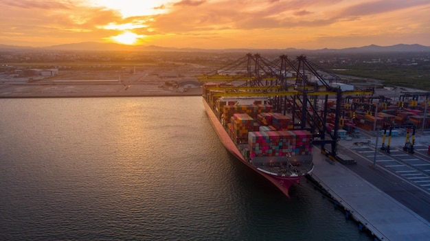 Foto guindaste emprestando contêiner de carga para navio porta-contêineres no conceito de porto de terminal internacional transporte de mercadorias por navio ao nascer do sol