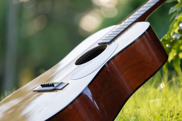 Guitarra acústica al aire libre sobre fondo verde Concepto de música tranquila