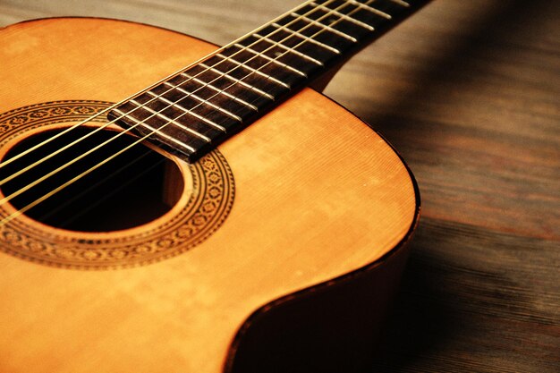 Guitarra acústica em fundo de madeira