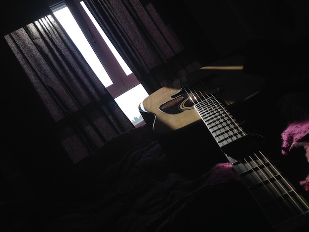 Foto la guitarra en la cama en casa