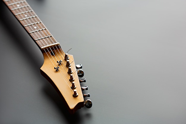 Guitarra eléctrica, vista de cerca en la cabeza. Instrumento musical de cuerda, sonido electro, música electrónica, equipamiento para concierto escénico