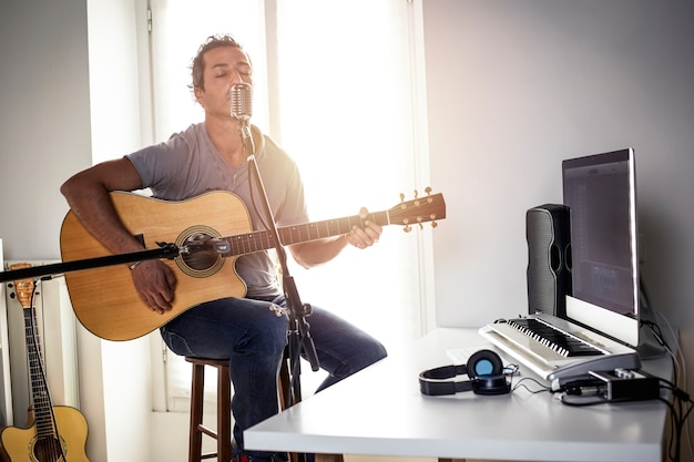 Guitarrista gravando em estúdio caseiro