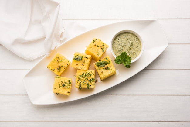 Gujarati Khaman Dhokla feito com Chana Dal, servido com chutney verde, foco seletivo