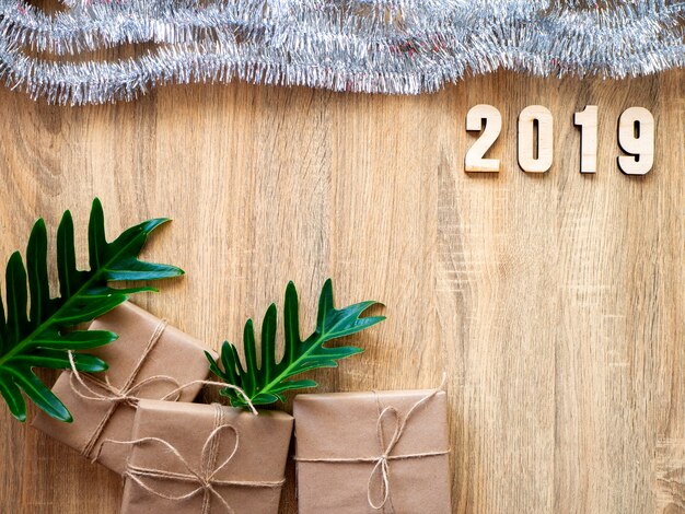 Guten Rutsch ins Neue Jahr 2019 dekorativ mit Geschenkbox auf hölzernem