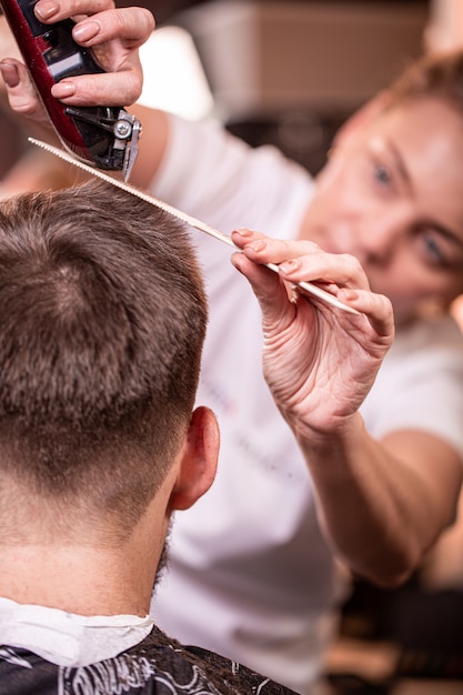 Haarschnitt Nahaufnahme. Hände, die einen Haarschneider halten.