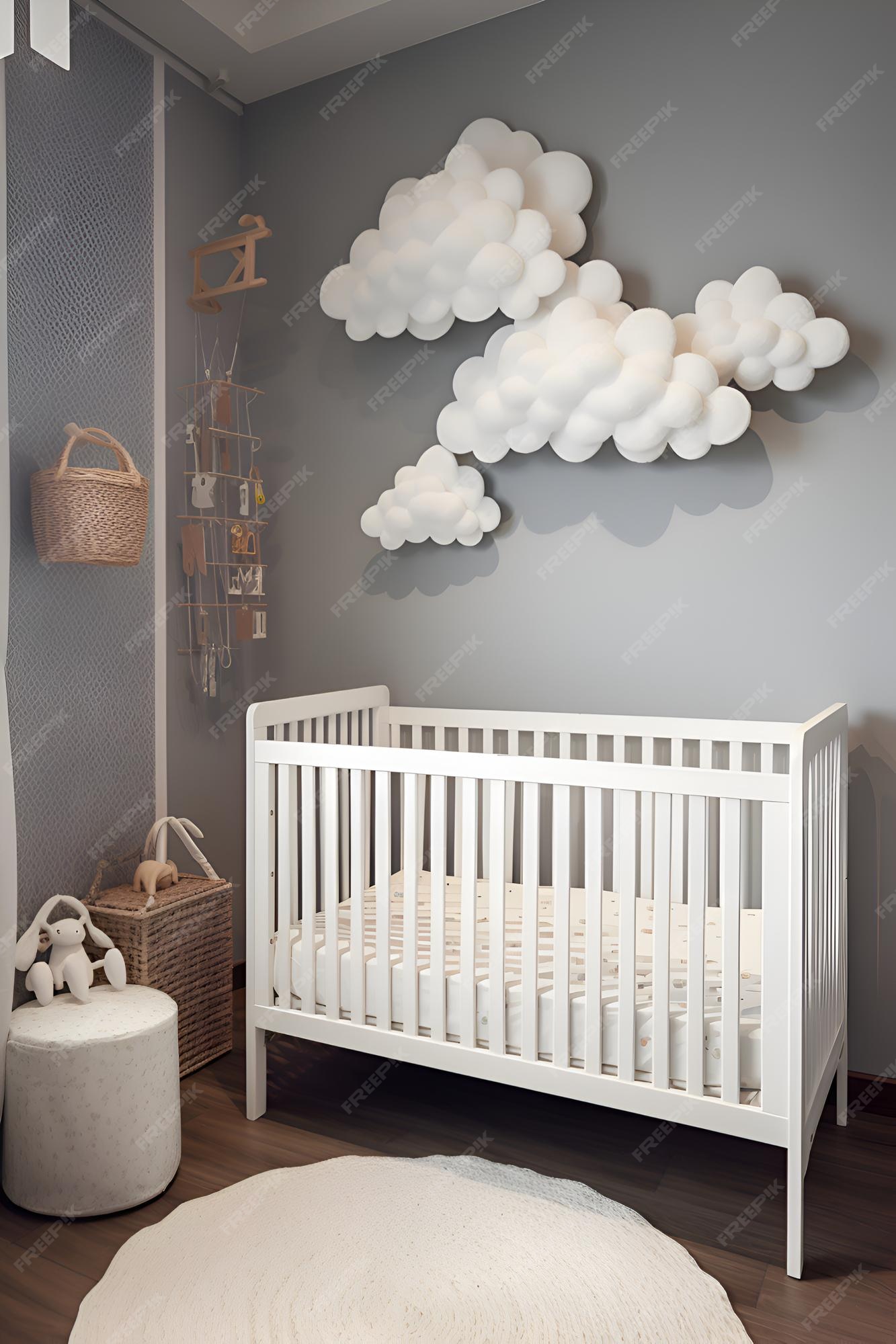 La habitación de un bebé con una cuna y una nube forma de nube colgando sobre ella. | Foto Premium