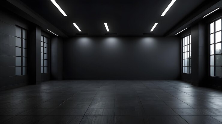 una habitación oscura con una pared negra y una luz en el techo