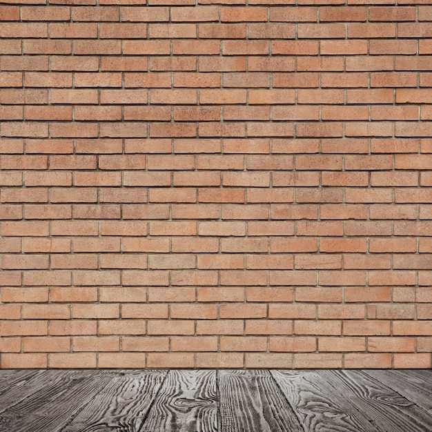 Habitación con pared de ladrillo y piso de madera.