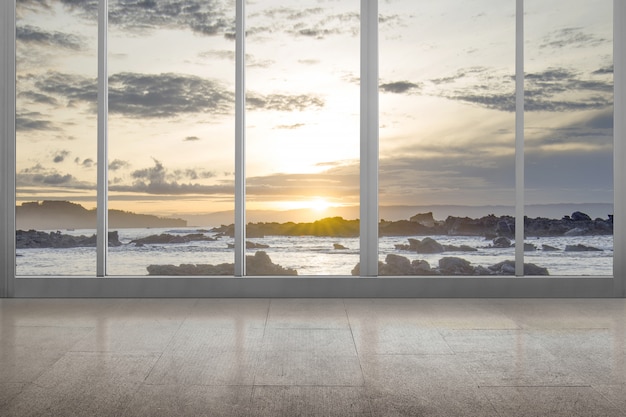 Habitación vacía con vista al mar y rocas