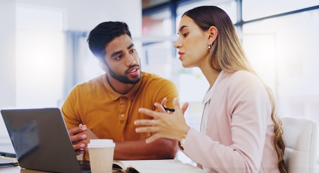 Foto hablando de capacitación y gente de negocios planeando una propuesta de lectura de computadora portátil y una estrategia en el trabajo colaboración de aprendizaje y un hombre y una mujer hablando mientras miran información en línea en la oficina