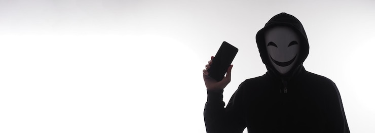 Foto hacker anónimo y mascarilla con smartphone en mano