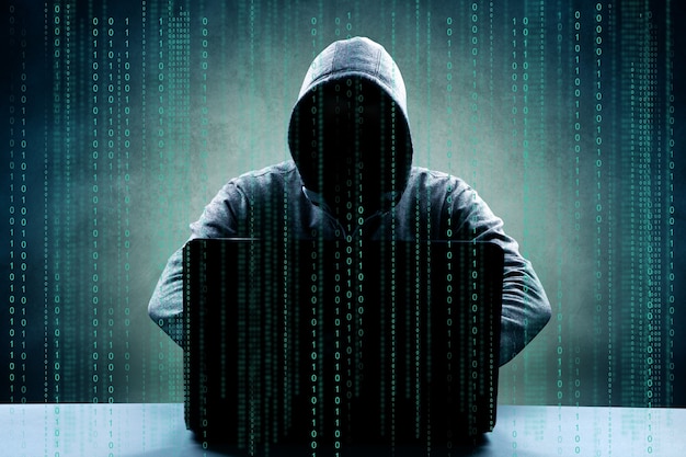 Hacker druckt einen Code auf eine Laptop-Tastatur, um in einen Cyberspace einzubrechen