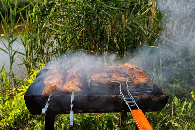 Hähnchenspieße werden auf Spießen und einem Grillrost gebraten