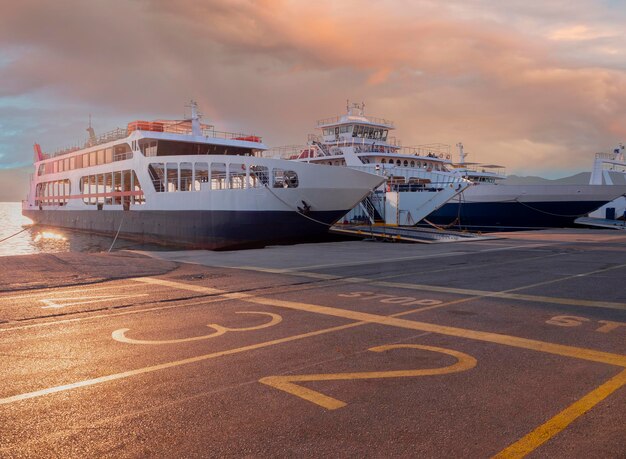 Hafen mit Fähre bei Sonnenuntergang in einem Kurort Loutra Edipsou auf der griechischen Insel Euböa in Griechenland