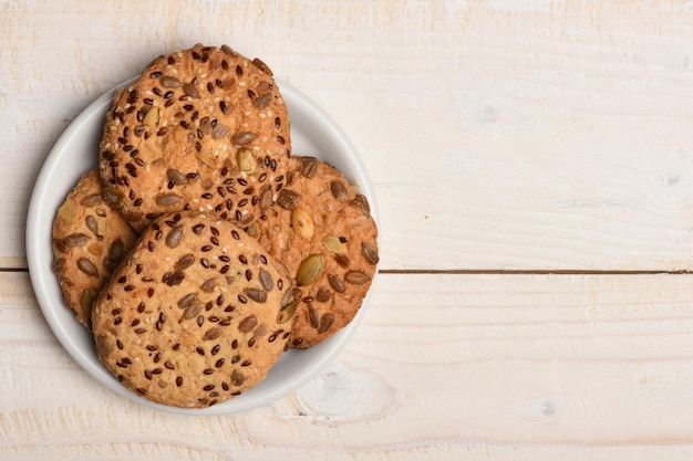 Haferkekse mit Samen auf weißem alten Holztisch mit Platz für Text frisch gebackener Kopierraum Konzept für Gebäck und hausgemachte Waren