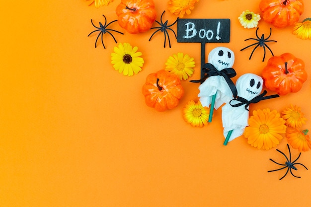 Halloween Party Dekorierte Kindernahrung Dekoration Lutscher in einer weißen Serviette und Spinnenkürbisse