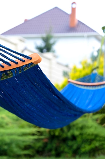 Hamaca azul colgada en el jardín trasero