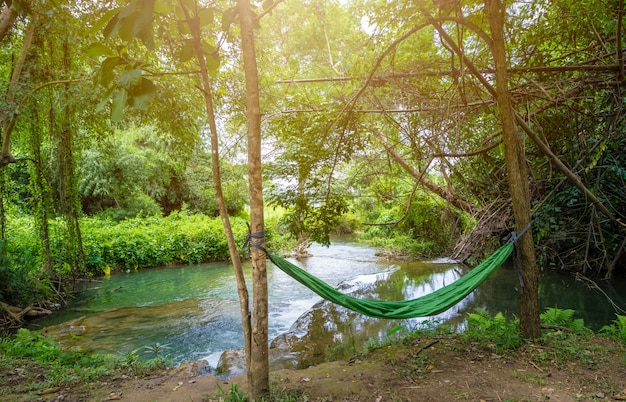 Hamaca entre dos árboles cerca de la cascada en el camping