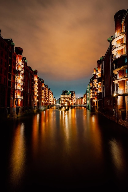 Hamburgo Alemania Vista de Wandrahmsfleet al anochecer luz de iluminación con reflejo en el agua Situado en el distrito de almacenes Speicherstadt Punto de referencia del barrio de HafenCity