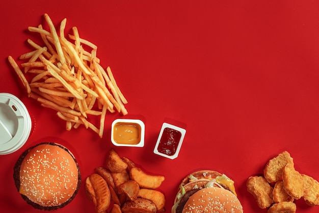 Hambúrguer com batatas fritas hambúrguer e batatas fritas em caixa de papel vermelha fast food sobre fundo vermelho