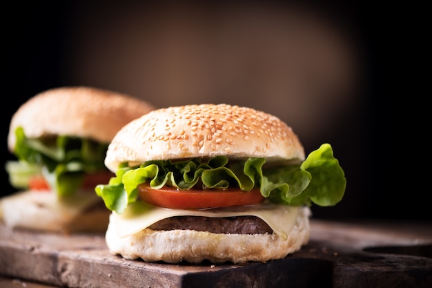 Hamburguesa casera sobre fondo de madera rústica. Cerrar detalles