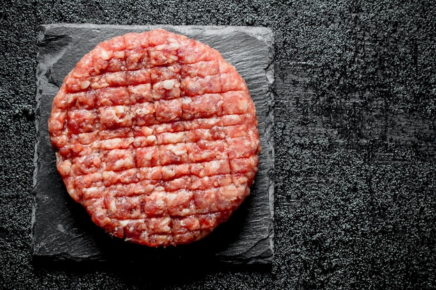 Foto una hamburguesa cruda en un puesto de piedra