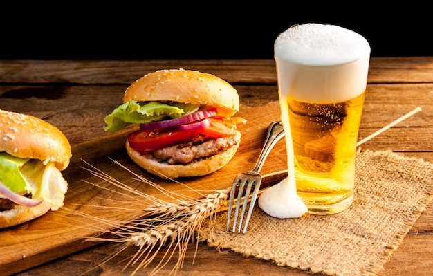 hamburguesa con jarra de cerveza en la mesa de madera