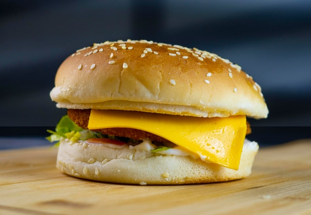 Foto una hamburguesa con queso y tomate encima