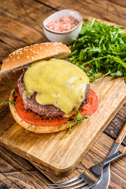 Hamburguesa de sandwich grande con ternera, tomate, queso y rúcula